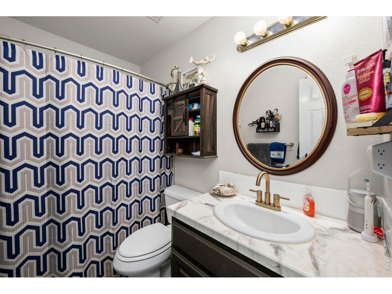 5225 West 11th Street Road Greeley, CO 80634 - Photo 4 of 17 a bathroom with a sink and a mirror