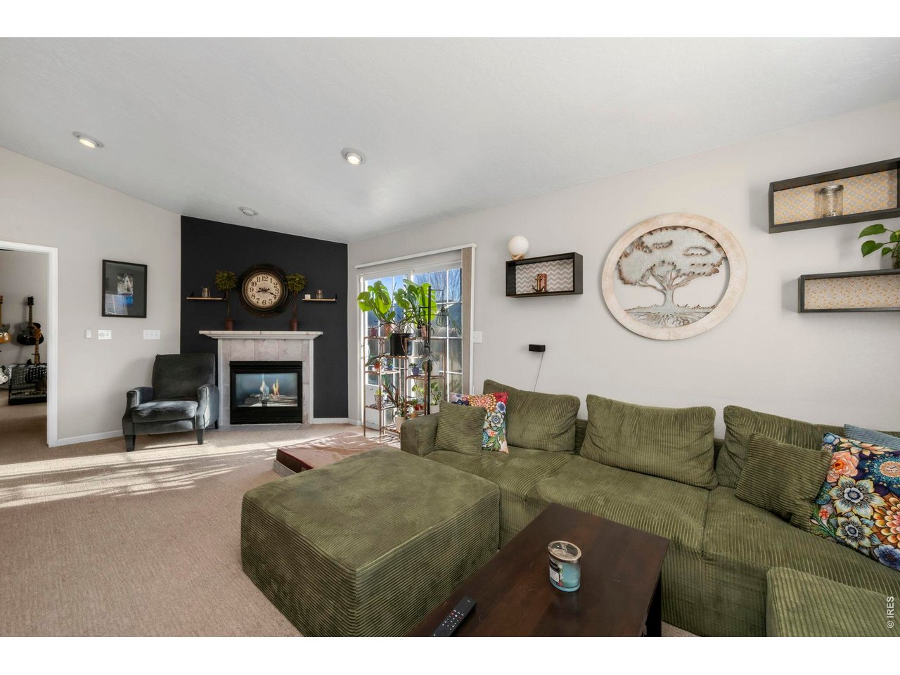 5225 West 11th Street Road Greeley, CO 80634 - Photo 5 of 17 a living room with furniture a clock and a fireplace