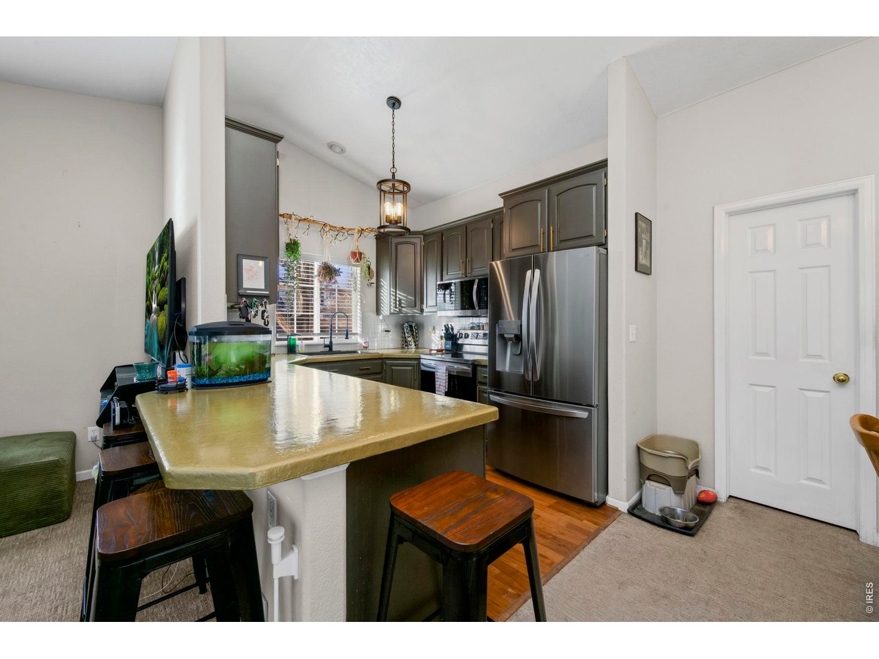 5225 West 11th Street Road Greeley, CO 80634 - Photo 7 of 17 a kitchen with stainless steel appliances a table chairs and refrigerator