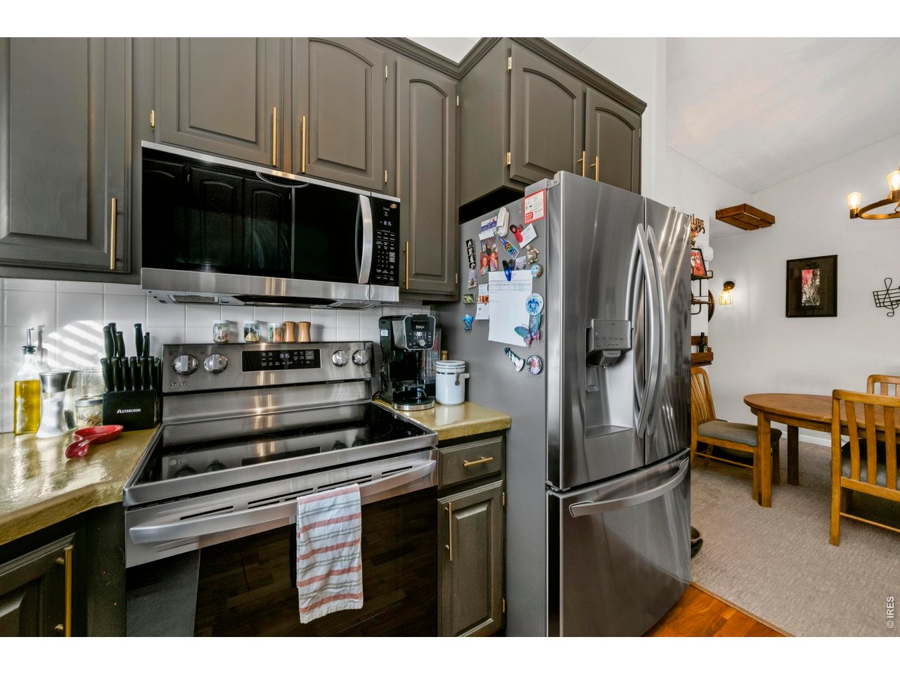 5225 West 11th Street Road Greeley, CO 80634 - Photo 8 of 17 a kitchen with stainless steel appliances a refrigerator a stove and a microwave