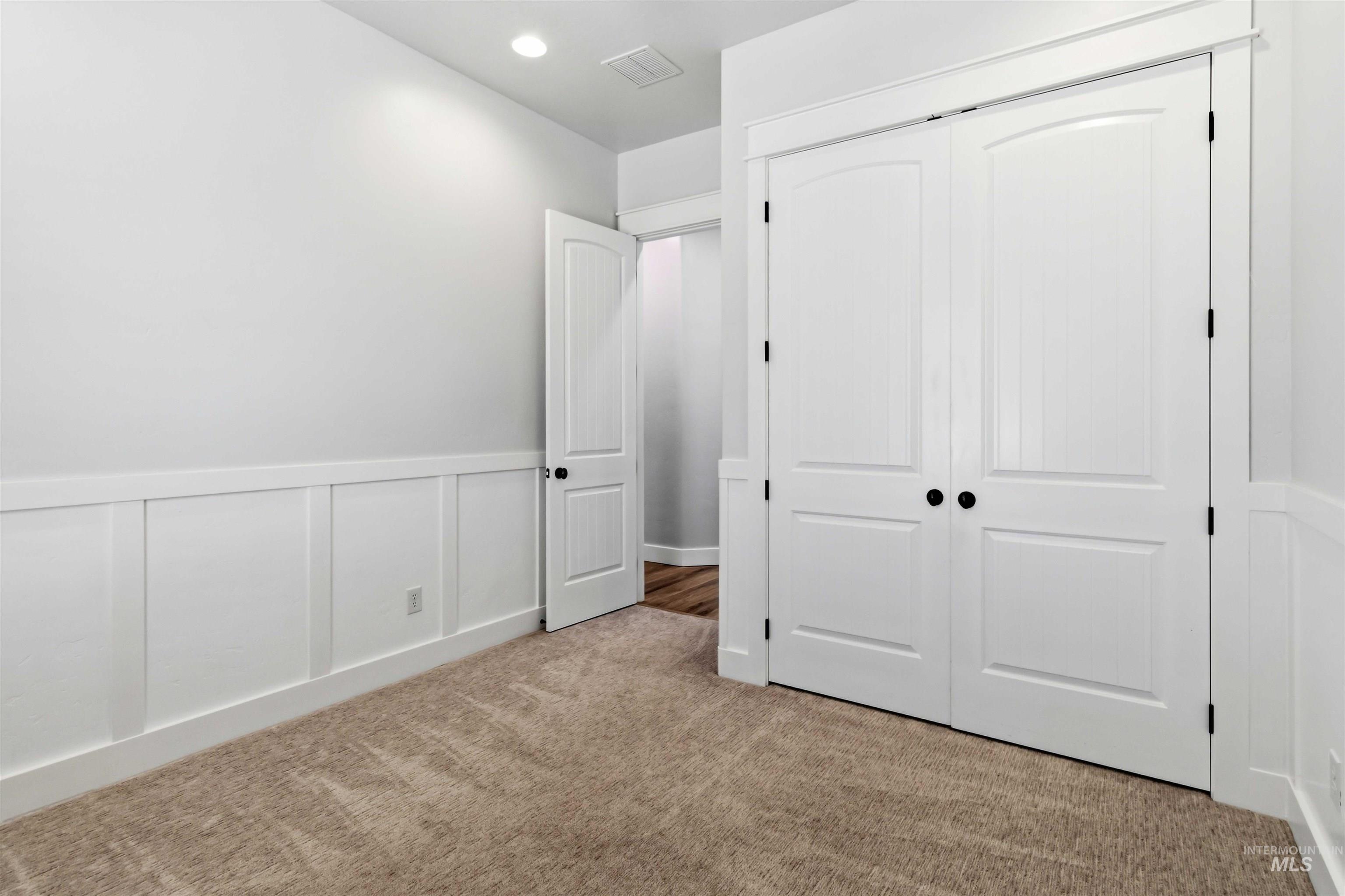 3218 North Cherry Laurel Way Star, ID 83669 - Photo 36 of 50 Recessed lighting illuminates this room featuring wainscoting, a single window with blinds, and soft carpet flooring
