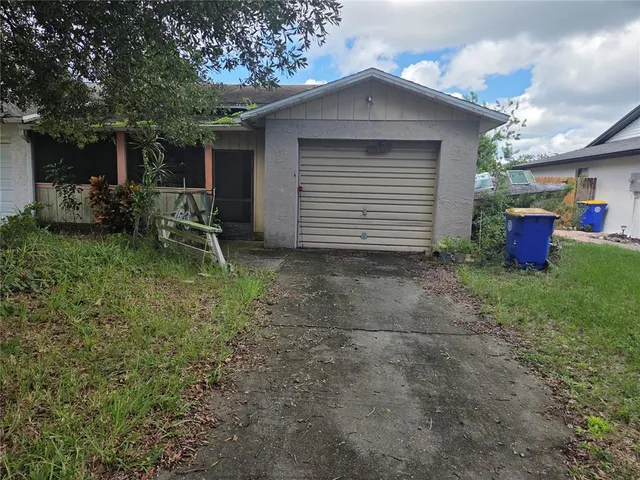 a backyard of a house with table and chairs