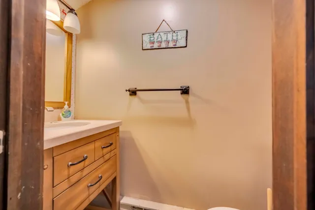 a bathroom with a granite countertop sink a mirror and vanity