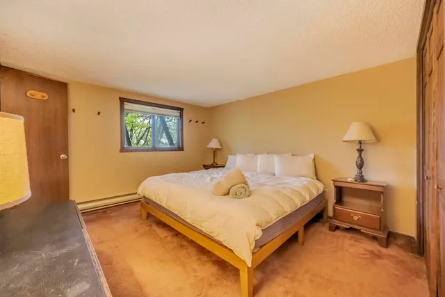 a bedroom with a bed and a night stand