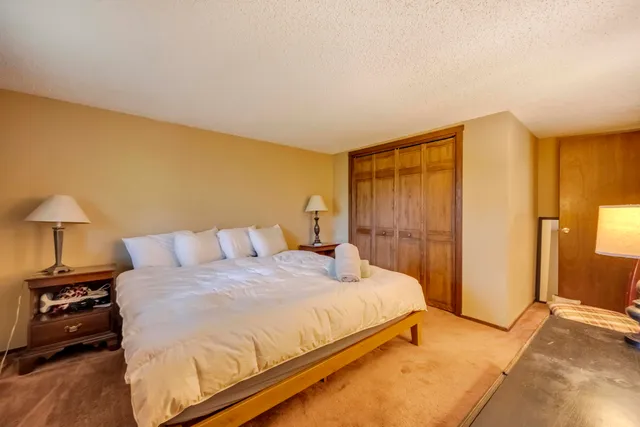 a bedroom with a bed and a night stand