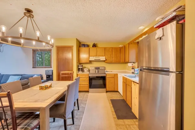 a kitchen with stainless steel appliances a stove a sink dishwasher and a refrigerator