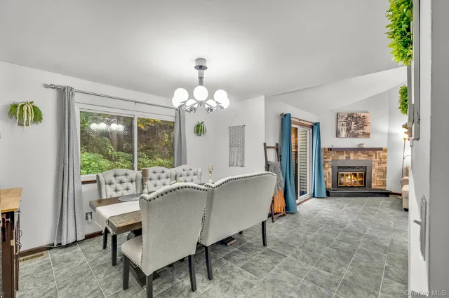 a living room with furniture chandelier and a mirror