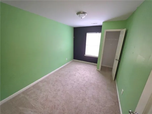a view of a room with a fan and window