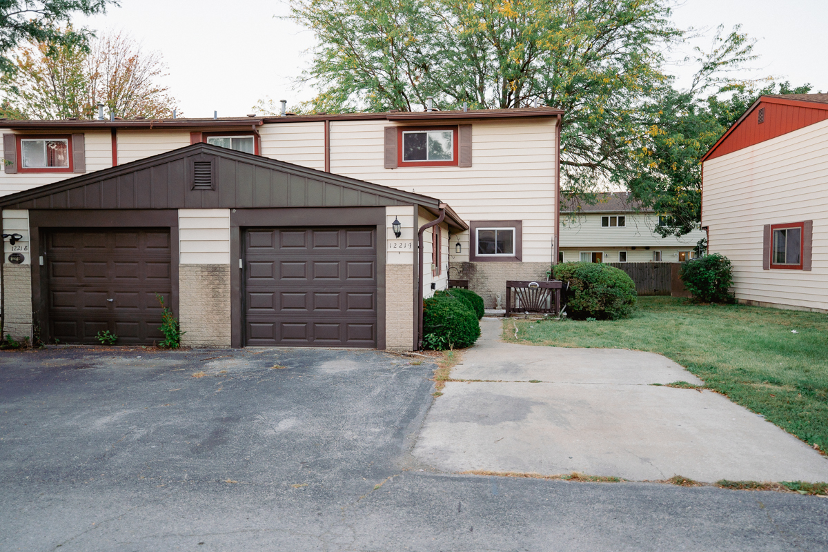 1221 Cedarwood Drive, Unit F Crest Hill, IL 60403 - Photo 1 of 35 a front view of a house with a yard