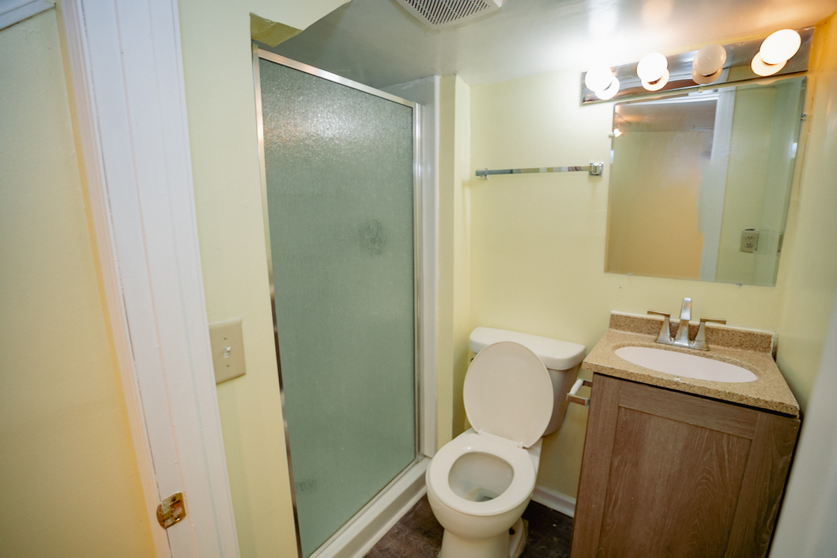1221 Cedarwood Drive, Unit F Crest Hill, IL 60403 - Photo 13 of 35 a bathroom with a granite countertop toilet sink and mirror