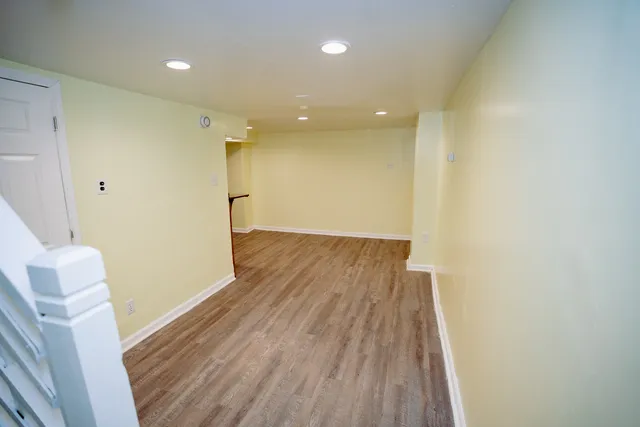 a view of hallway with wooden floor