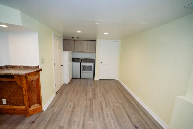 a view of a kitchen with a sink and a refrigerator