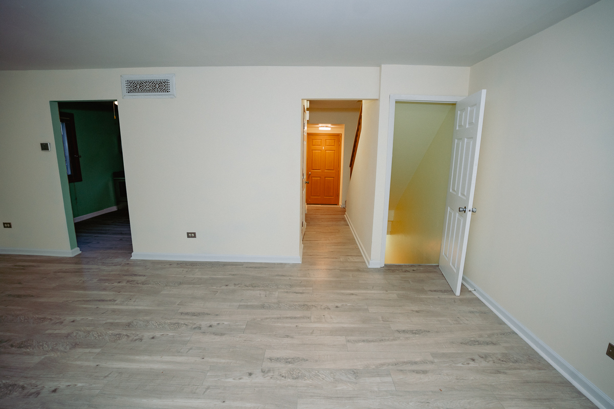 1221 Cedarwood Drive, Unit F Crest Hill, IL 60403 - Photo 20 of 35 a view of an empty room with wooden floor and closet