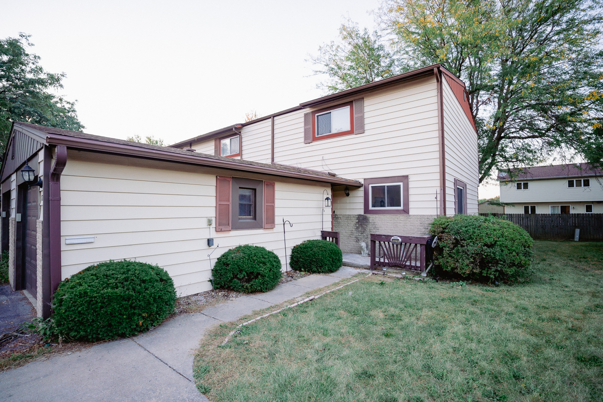 1221 Cedarwood Drive, Unit F Crest Hill, IL 60403 - Photo 2 of 35 a front view of a house with garden