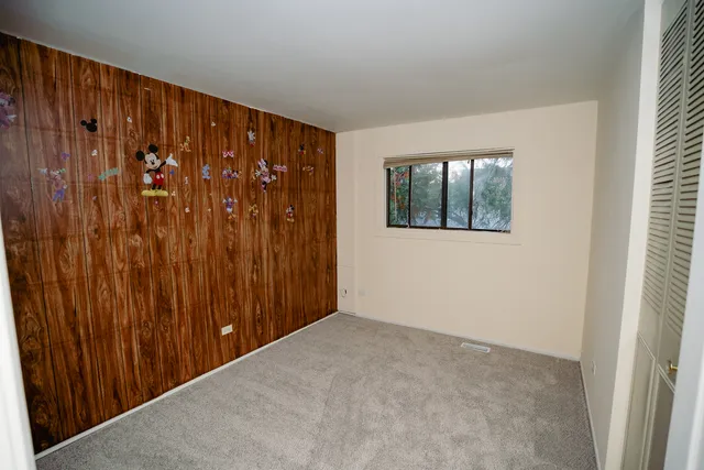 a view of an empty room with wooden walls