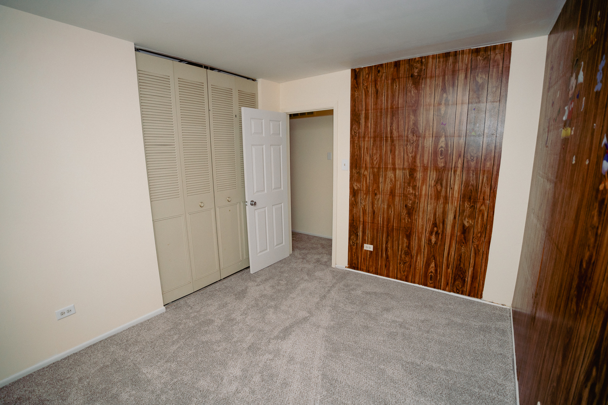 1221 Cedarwood Drive, Unit F Crest Hill, IL 60403 - Photo 27 of 35 a view of an empty room with wooden walls