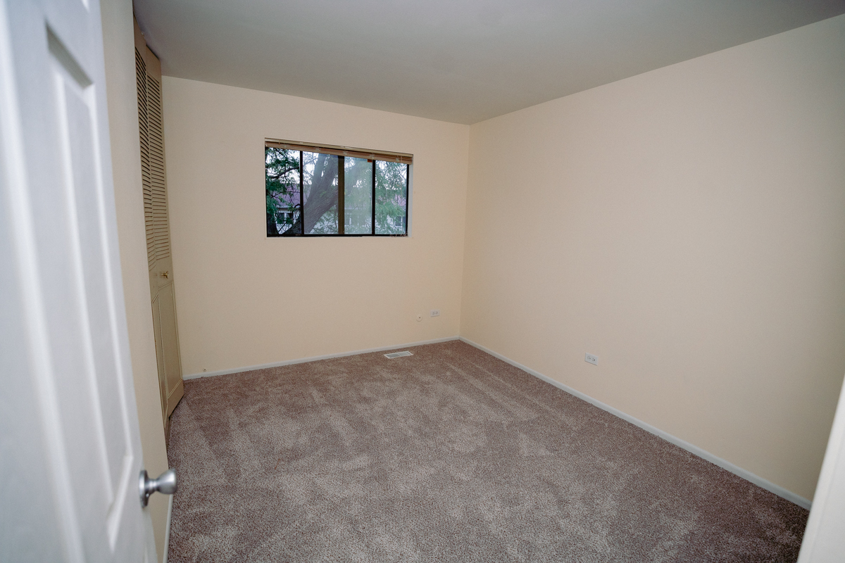 1221 Cedarwood Drive, Unit F Crest Hill, IL 60403 - Photo 28 of 35 a view of an empty room with windows