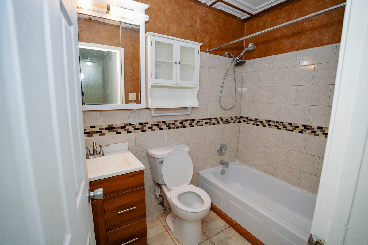 1221 Cedarwood Drive, Unit F Crest Hill, IL 60403 - Photo 30 of 35 a bathroom with a sink a toilet and shower