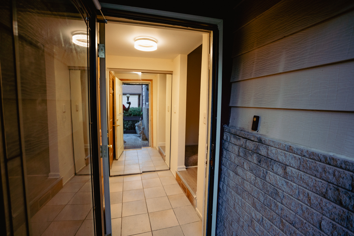 1221 Cedarwood Drive, Unit F Crest Hill, IL 60403 - Photo 3 of 35 a view of a hallway with wooden floor and a bathroom