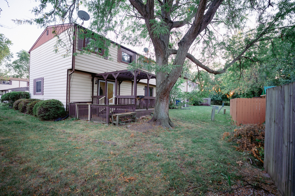 1221 Cedarwood Drive, Unit F Crest Hill, IL 60403 - Photo 35 of 35 a view of a house with a yard and sitting area