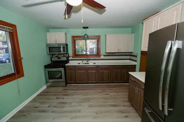 a kitchen with stainless steel appliances a stove sink and refrigerator