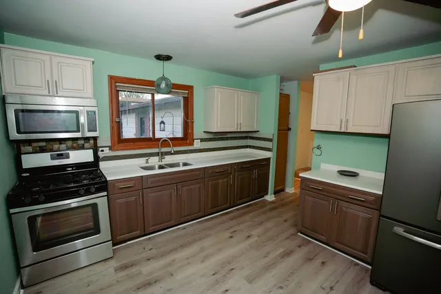 a kitchen with a sink stove and microwave