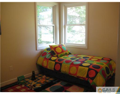 211 Lambertson Road Old Bridge, NJ 07747 - Photo 13 of 19 a bedroom with a bed and a window
