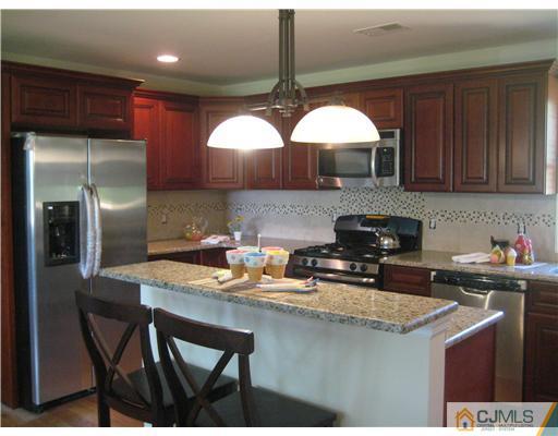 211 Lambertson Road Old Bridge, NJ 07747 - Photo 5 of 19 a kitchen with stainless steel appliances granite countertop a sink refrigerator and cabinets