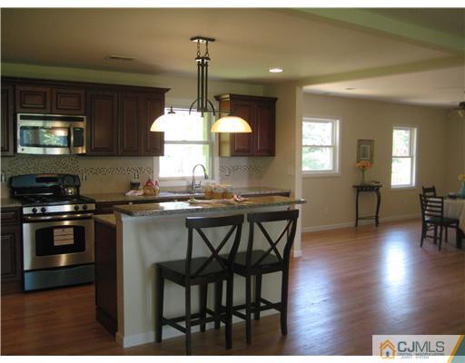 211 Lambertson Road Old Bridge, NJ 07747 - Photo 7 of 19 a kitchen with dining table and chairs