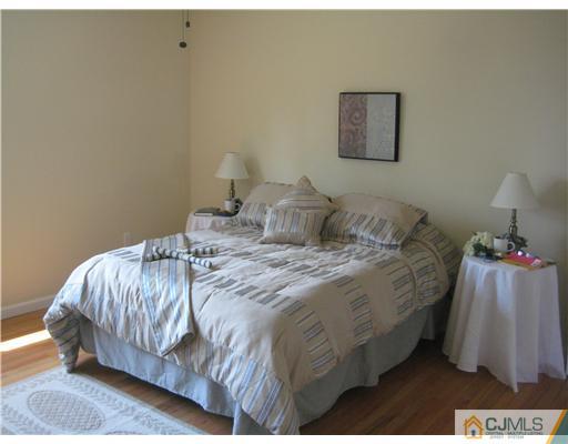 211 Lambertson Road Old Bridge, NJ 07747 - Photo 10 of 19 a bedroom with a bed and a lamp on table