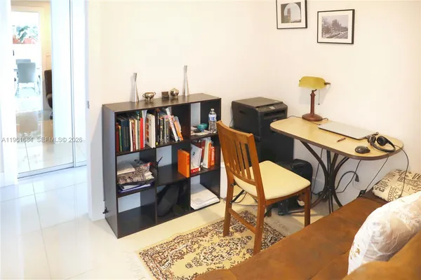 a living room with furniture and a book shelf