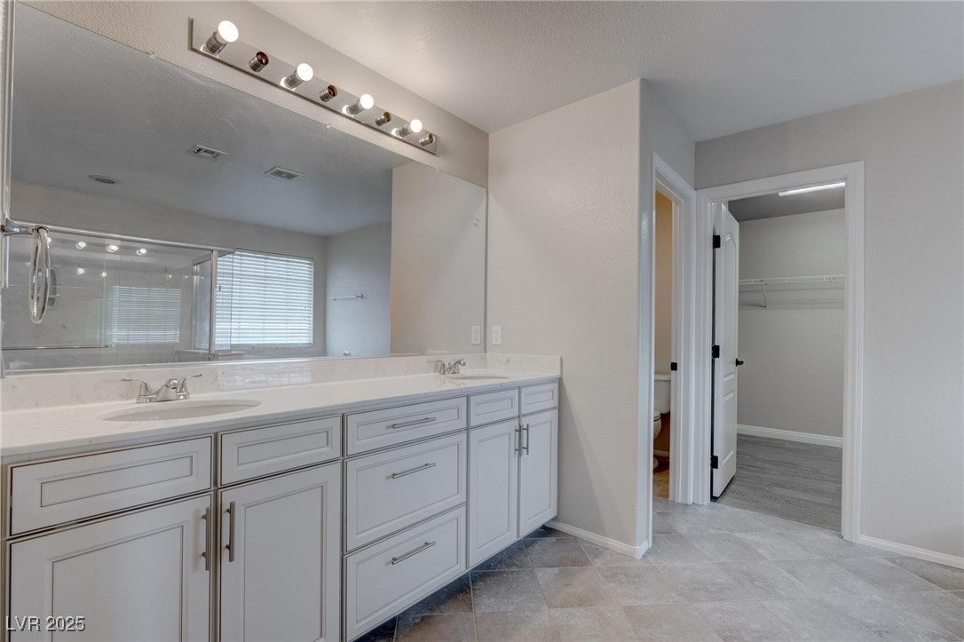 10273 Aragon Crown Road Las Vegas, NV 89135 - Photo 11 of 45 Full bath featuring double vanity, a spacious closet, and a stall shower