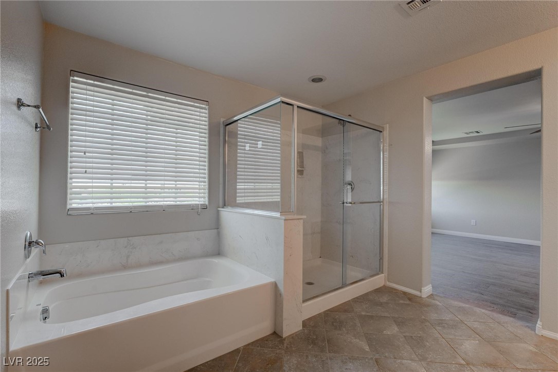 10273 Aragon Crown Road Las Vegas, NV 89135 - Photo 14 of 45 Bathroom featuring a garden tub and a stall shower