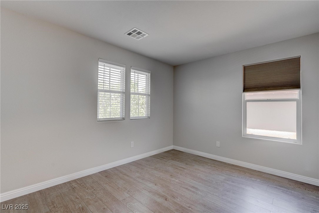 10273 Aragon Crown Road Las Vegas, NV 89135 - Photo 18 of 45 Spare room with baseboards and light wood-type flooring