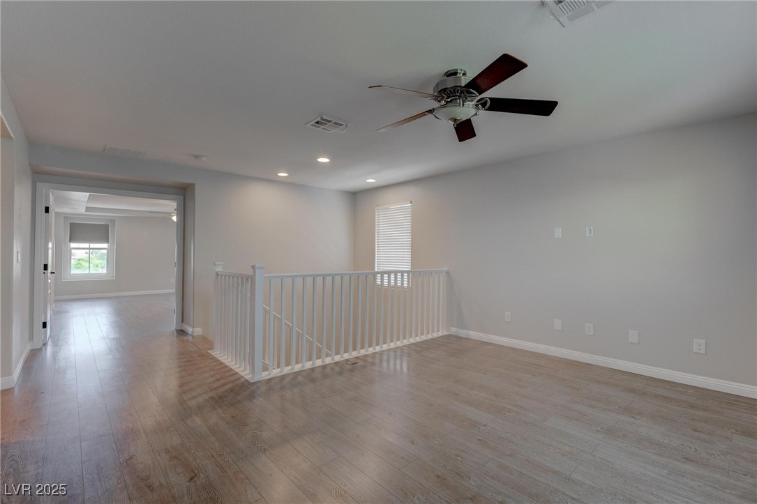 10273 Aragon Crown Road Las Vegas, NV 89135 - Photo 22 of 45 Empty room featuring recessed lighting, light wood-style floors, and a ceiling fan