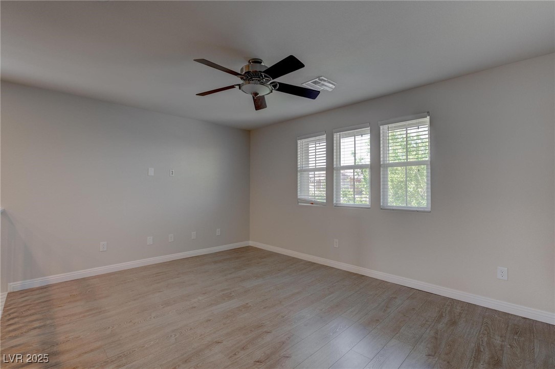 10273 Aragon Crown Road Las Vegas, NV 89135 - Photo 24 of 45 Spare room with light wood-type flooring and a ceiling fan