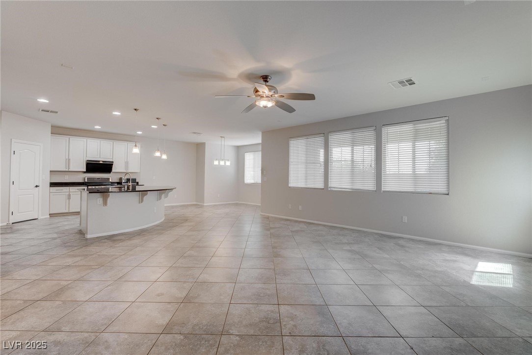 10273 Aragon Crown Road Las Vegas, NV 89135 - Photo 26 of 45 Unfurnished living room featuring light tile patterned flooring, recessed lighting, and a ceiling fan