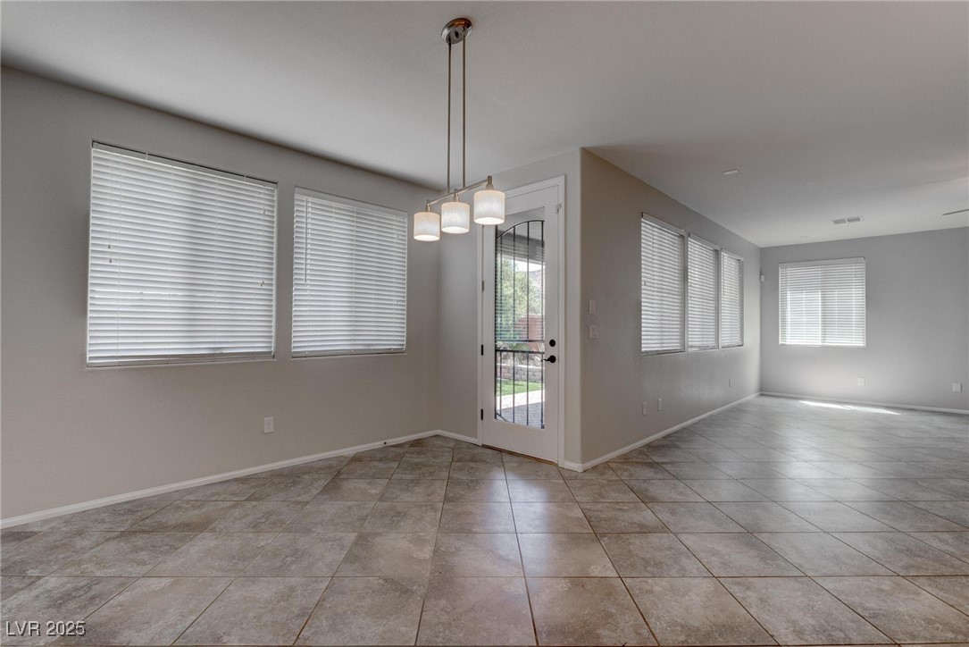 10273 Aragon Crown Road Las Vegas, NV 89135 - Photo 33 of 45 Spare room featuring baseboards and light tile patterned flooring