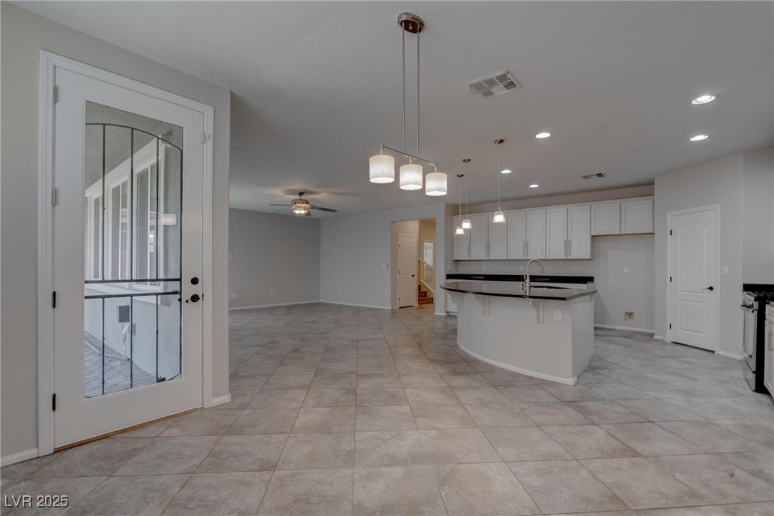 10273 Aragon Crown Road Las Vegas, NV 89135 - Photo 45 of 45 Kitchen featuring recessed lighting, open floor plan, pendant lighting, ceiling fan, and an island with sink