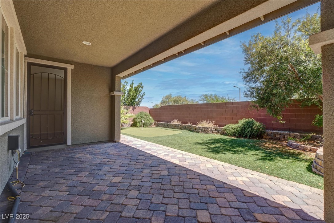 10273 Aragon Crown Road Las Vegas, NV 89135 - Photo 37 of 45 Fenced backyard with a patio and a putting green