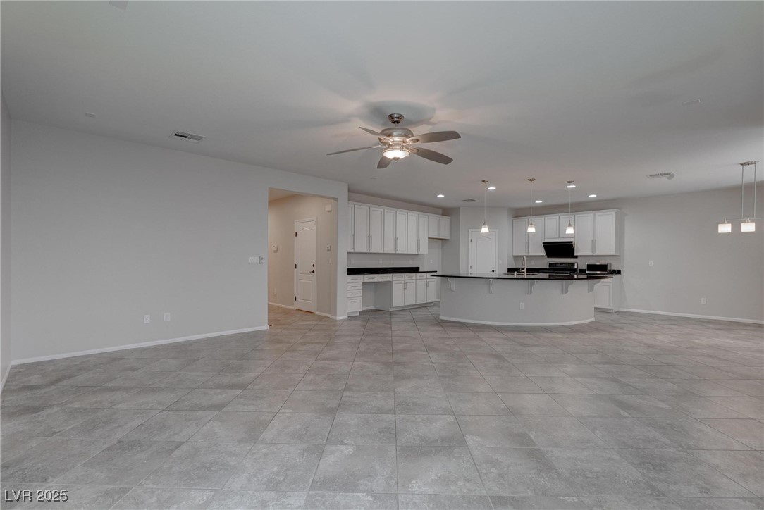 10273 Aragon Crown Road Las Vegas, NV 89135 - Photo 4 of 45 Unfurnished living room with ceiling fan and recessed lighting