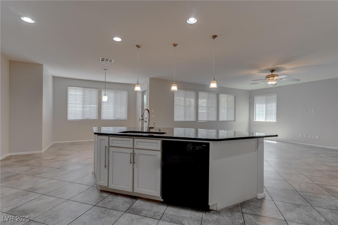 10273 Aragon Crown Road Las Vegas, NV 89135 - Photo 44 of 45 Kitchen with hanging light fixtures, open floor plan, black dishwasher, white cabinets, and ceiling fan