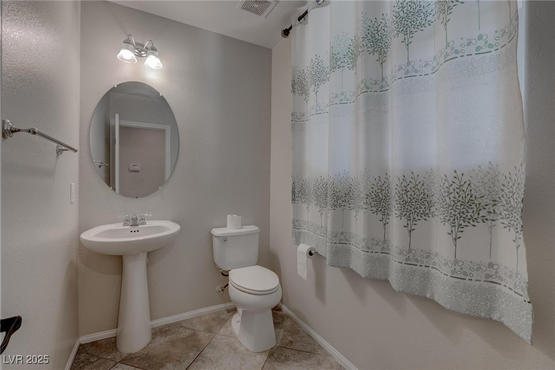 10273 Aragon Crown Road Las Vegas, NV 89135 - Photo 5 of 45 Full bath with light tile patterned flooring and a shower with curtain