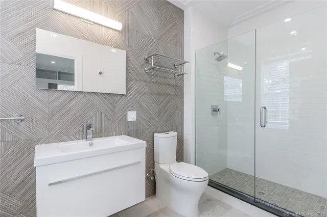 a bathroom with a toilet sink and shower