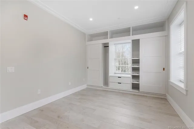 an empty room with closet and cabinet