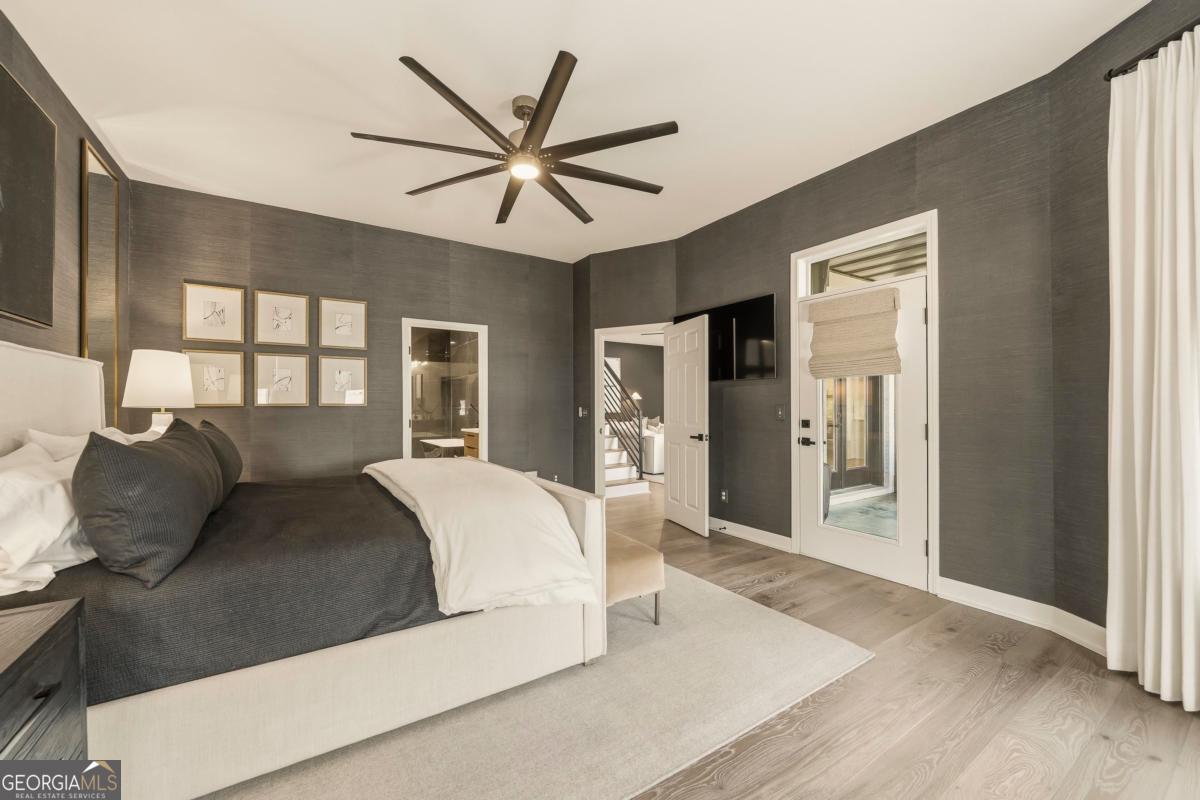 121 Mags Path Eatonton, GA 31024 - Photo 24 of 74 a bedroom with a large bed and a chandelier