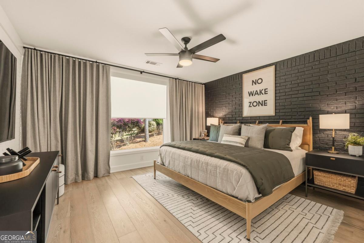 121 Mags Path Eatonton, GA 31024 - Photo 30 of 74 a spacious bedroom with a bed and a large window