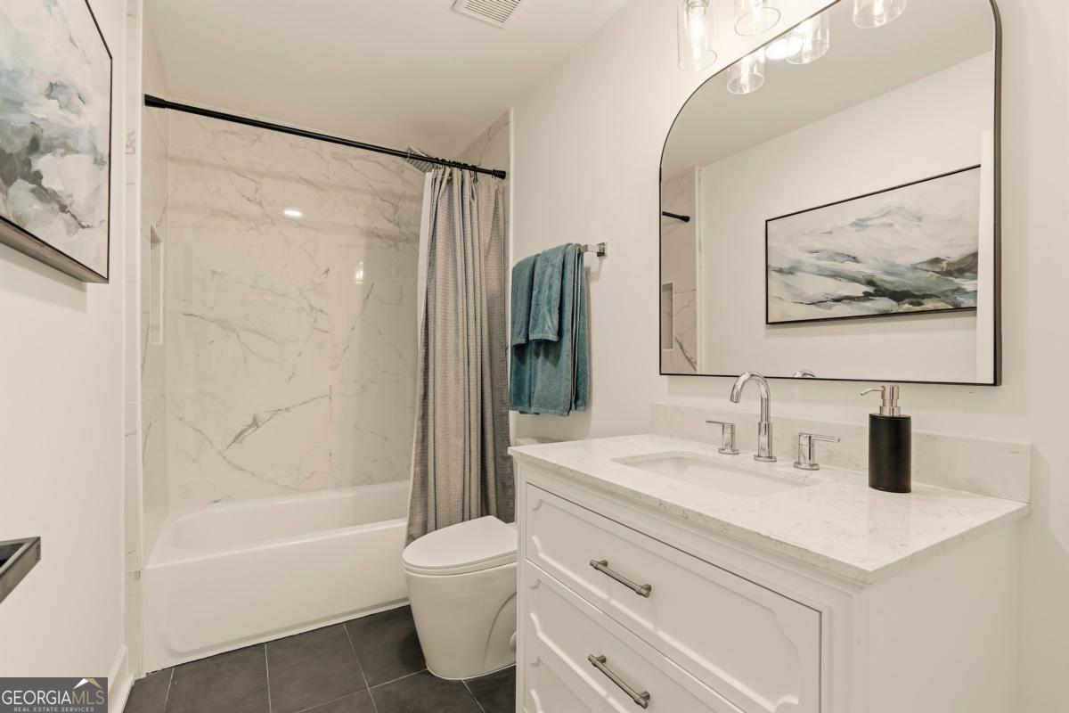 121 Mags Path Eatonton, GA 31024 - Photo 32 of 74 a bathroom with a sink mirror toilet and bathtub
