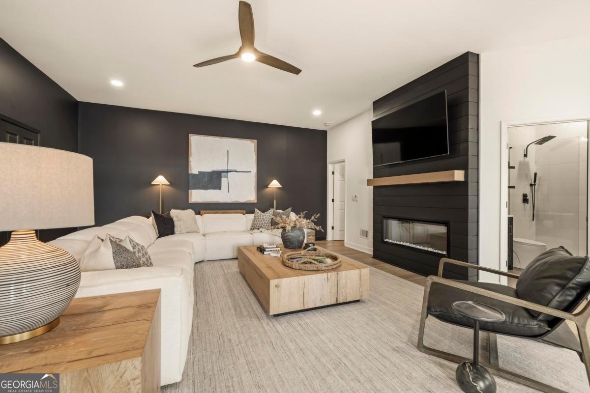 121 Mags Path Eatonton, GA 31024 - Photo 39 of 74 a living room with furniture flat screen tv and a fireplace