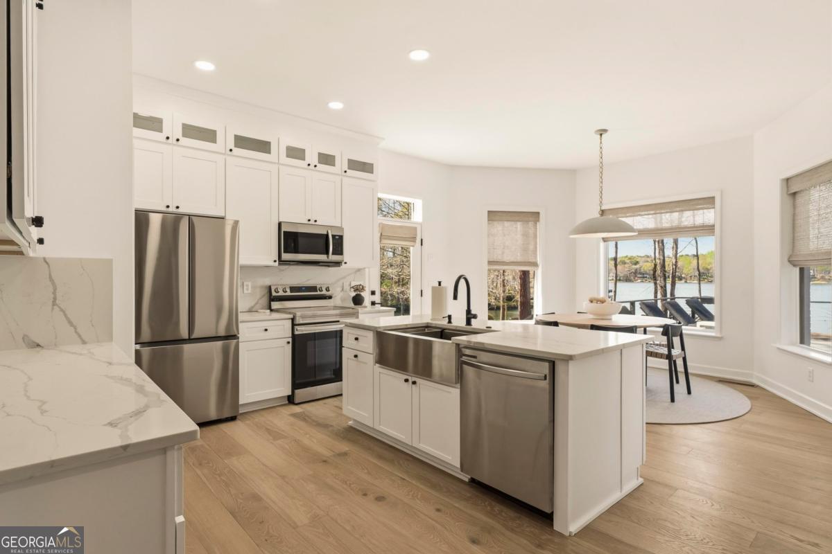 121 Mags Path Eatonton, GA 31024 - Photo 44 of 74 a kitchen with a sink a counter top space stainless steel appliances and cabinets